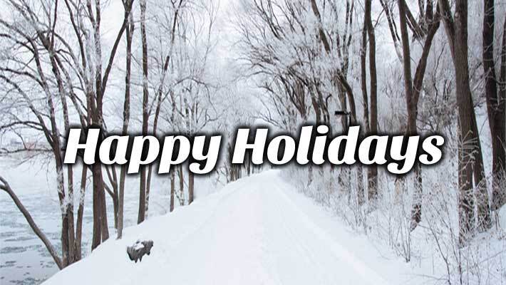 Snow covered path in the forest with the text Happy Holidays.