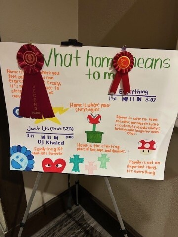 Ishir Williams poster on a stand  with a 2nd place ribbon hanging off of it. 