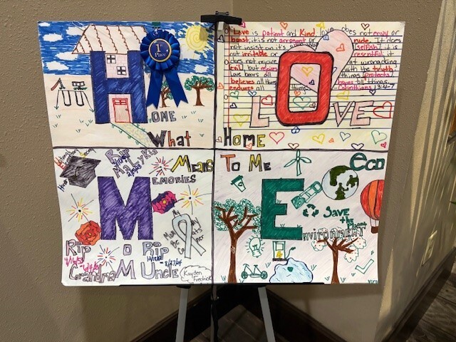 Kayden Fredrick's poster displayed on a stand.