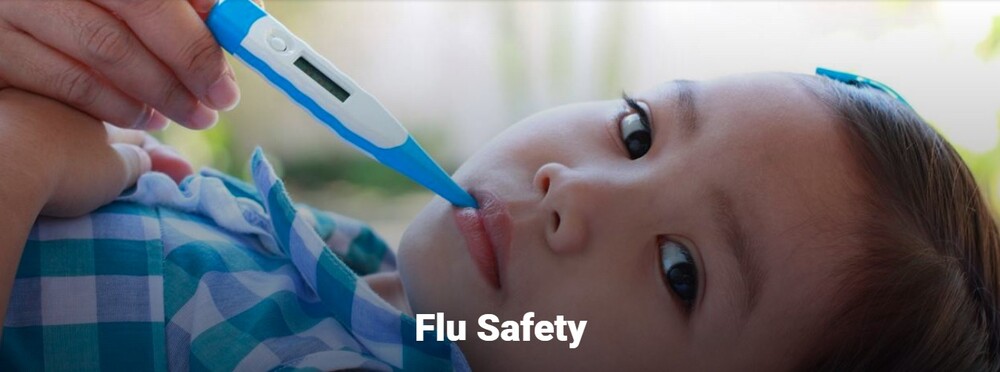 Flu safety. A young child with a thermometer in their mouth.